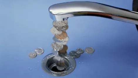 Money flowing from tap