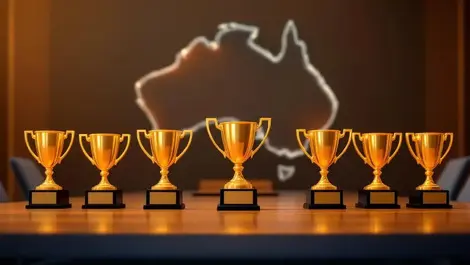 Nine golden business awards on table australia outline background